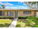 Tan house exterior with green door and landscaping at 725 Northlake Blvd # 45, Altamonte Springs, FL 32701