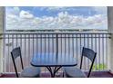 Balcony with table and chairs overlooking water at 145 N Halifax Ave # 608, Daytona Beach, FL 32118