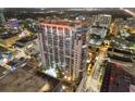 Night aerial view of a modern highrise building with a pool at 155 S Court Ave # 2609, Orlando, FL 32801