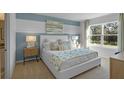 Bright bedroom with a comfortable bed, stylish decor, and large window at 4185 Singing Mockingbird Blvd, Bartow, FL 33830