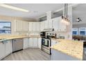 Well-equipped kitchen featuring stainless steel appliances and granite countertops at 711 Polo Park Blvd, Davenport, FL 33897