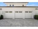 Three-car garage with white doors and a paved driveway at 1948 Rowena Ave, Orlando, FL 32803