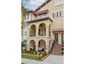 Three-story townhome with stucco exterior, arched entryways, and balcony at 2108 Lobelia Dr, Lake Mary, FL 32746