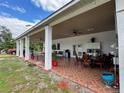Covered patio with dining furniture, ceiling fans, and tiled flooring at 2109 Morning Dr, Orlando, FL 32809