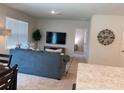 Spacious living room featuring a large TV and comfortable seating at 310 Gardenia Ct, Poinciana, FL 34759