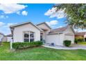 Front view of a single-story house with a landscaped yard and a two-car garage at 968 Jaybee Ave, Davenport, FL 33897