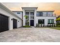 Contemporary home with a two-car garage and paver driveway at 15614 Espalier Way, Winter Garden, FL 34787