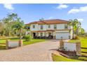 Large two-story house with a brick driveway and landscaped front yard at 19206 Robertson St, Orlando, FL 32833