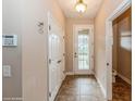 Tiled entryway with coat closet and half bathroom at 3006 Seaview Castle Dr, Kissimmee, FL 34746