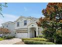 Two-story house with a white exterior and landscaping at 1680 Moon Valley Dr, Davenport, FL 33896