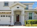 Elegant front door entry with stone columns and an arched entryway at 1680 Moon Valley Dr, Davenport, FL 33896