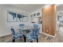 Small dining area with glass table and zebra-print chairs, adjacent to a built-in bar at 4225 S Atlantic Ave # 226, New Smyrna Beach, FL 32169