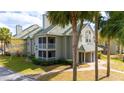 Side view of a two-story condo with palm trees and screened balcony at 6088 Westgate Dr # 204, Orlando, FL 32835