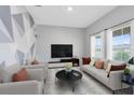 Spacious living room with large windows and comfortable seating at 729 Hitch Loop, St Cloud, FL 34772