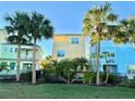 Row of colorful townhomes with lush landscaping at 8033 Surf St, Kissimmee, FL 34747