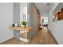 Bright and spacious entryway with modern wood and gray accents at 836 Desert Mountain Ct, Reunion, FL 34747