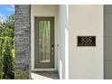 Modern front door with gray frame and a sleek design at 836 Desert Mountain Ct, Reunion, FL 34747