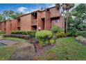 Condo building exterior showcasing landscaping and building features at 1038 E Michigan St # 1, Orlando, FL 32806