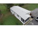 Single-wide mobile home with grey siding and screened porch at 1111 Sunflower Trl, Orlando, FL 32833
