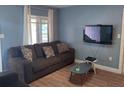 Living room featuring hardwood floors and comfy couch at 1523 Amaros Ave, Orlando, FL 32811