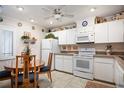 Bright kitchen with white cabinets, appliances, and a breakfast nook at 3 Escondido Cir # 18, Altamonte Springs, FL 32701