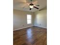 Spacious bedroom with wood-look tile flooring and ceiling fan at 3467 Arabesque Dr, Deland, FL 32724