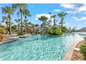 Resort-style pool with a waterslide in a tropical setting at 1431 Thunderbird Rd, Davenport, FL 33896