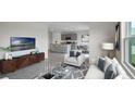 Open living room with adjacent kitchen and seating area at 2842 Moulin Rd, Davenport, FL 33837