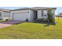 One story house with gray siding, brown roof and landscaped lawn at 4702 Jasmine Cir, Leesburg, FL 34748