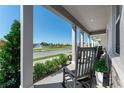 Relaxing front porch with rocking chairs overlooking a pond at 5538 Stockade Blvd, Saint Cloud, FL 34771