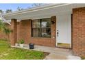 Front entrance with white door and brick facade at 857 S Atmore Cir, Deltona, FL 32725