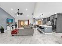 Open concept living room and kitchen with gray cabinets and marble floors at 857 S Atmore Cir, Deltona, FL 32725