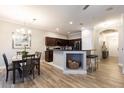Spacious kitchen with island, dark cabinets, stainless steel appliances, and hardwood floors at 875 Assembly Ct, Reunion, FL 34747