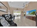 Spacious living room with a large TV and comfortable seating at 543 Clubhill Dr, Haines City, FL 33844