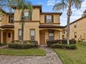 Front view of two-story townhome with landscaped yard at 408 Miramar Avenue, Davenport, FL 33897