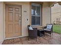 Small front patio with two wicker chairs and a side table at 408 Miramar Avenue, Davenport, FL 33897