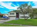 Two-story house with a spacious yard and mature tree at 664 Little Wekiva Rd, Altamonte Springs, FL 32714