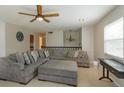 Open living area with comfortable sectional sofa and large windows at 664 Little Wekiva Rd, Altamonte Springs, FL 32714