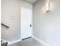 Modern entryway with white door and tiled floor at 7740 Sandy Ridge Dr # 141, Reunion, FL 34747