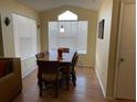 Dining area with wood floor, table and chairs, and large window at 2202 Key West Ct # 632, Kissimmee, FL 34741