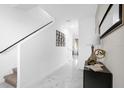 Bright entryway with marble floors, staircase, and a modern console table at 397 Madison Dr, Davenport, FL 33837