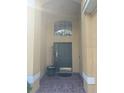 Front entrance with a tiled floor and a potted plant at 4704 Delray Beach Ct, Kissimmee, FL 34746