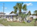 Rear view of a light green bungalow with a deck and AC unit at 5305 S Ridgewood Ave, Port Orange, FL 32127