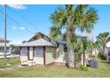 Another side view of the house showing the front door and landscaping at 5305 S Ridgewood Ave, Port Orange, FL 32127