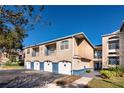 Condo building with attached garages and manicured lawn at 7270 Westpointe Blvd # 914, Orlando, FL 32835