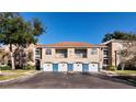 Condo building with garages and a spacious parking area at 7270 Westpointe Blvd # 914, Orlando, FL 32835