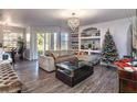 Spacious living room with hardwood floors, a sofa, and a Christmas tree at 7270 Westpointe Blvd # 914, Orlando, FL 32835