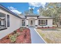 Welcoming front entrance with walkway and landscaping at 7360 Sw 137Th Court Rd, Dunnellon, FL 34432