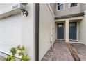 Front entry of townhome with double doors and brick walkway at 15211 Willow Arbor Cir, Orlando, FL 32824