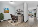 Bright home office with desk, chair, and built-in shelving at 15211 Willow Arbor Cir, Orlando, FL 32824